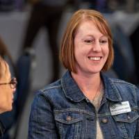 Smiling women chatting over lunch